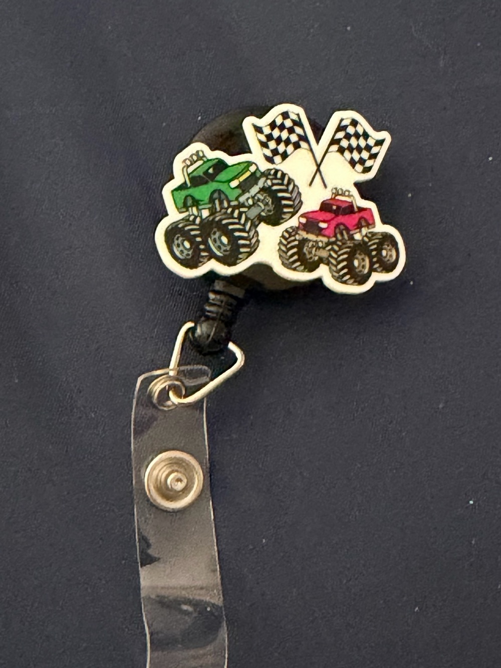 Monster Truck Badge Reel with Green and Pink Trucks